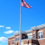 A picture of a USA flag hosted at a school campus