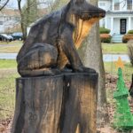 A wooden statue of a frog placed on the backyard